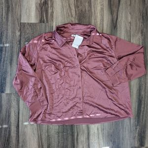 Long sleeved Collared Button Up, silky material with a pocket